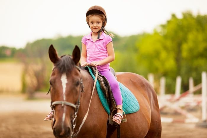 little girl riding on a horse