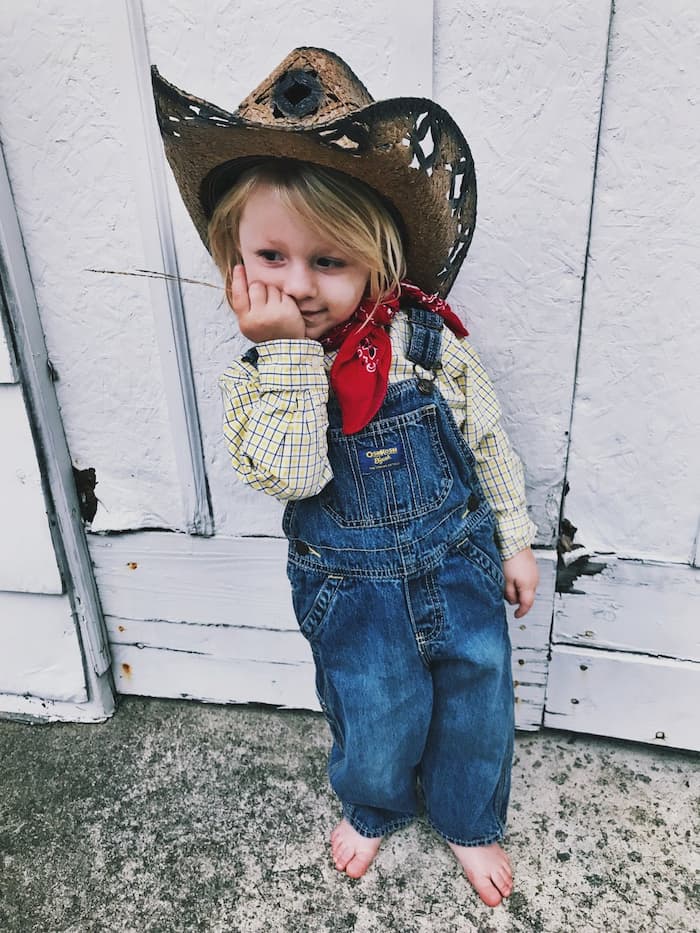 little girl with jeans shirt and hat for farm